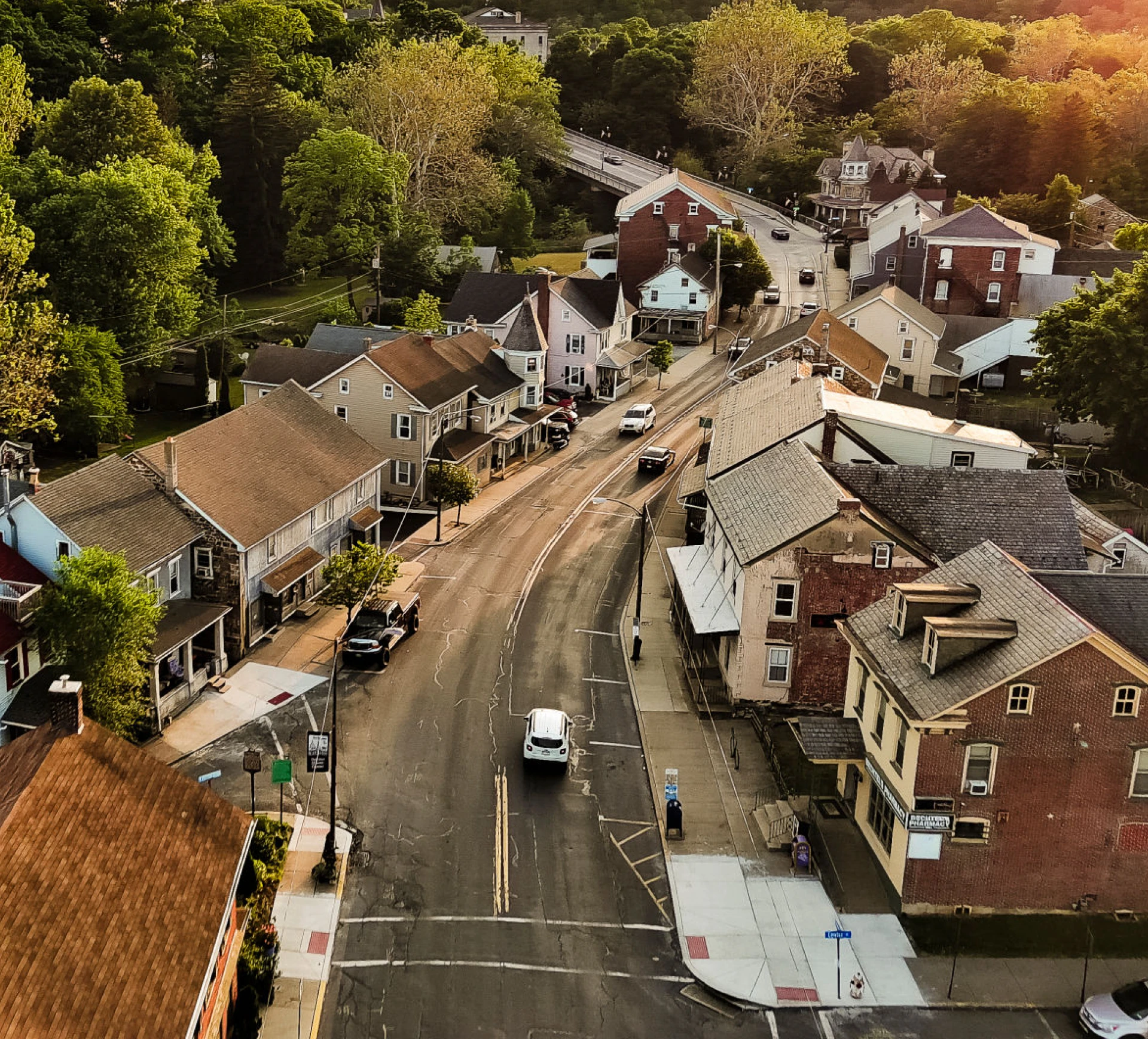 Quaint neighborhood with cars and trees